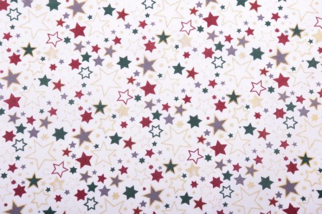 Vánoční látka z bavlny v jemném odstínu smetanové barvy s potiskem barevných hvězdič 12714/051