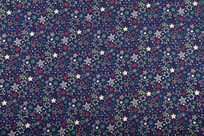 Vánoční látka z bavlny ve tmavě modré barvě s potiskem barevných hvězdiček 12714/008