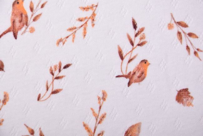Bavlněný úplet ve smetanové barvě s digitálním potiskem listů a ptáčků 184681
